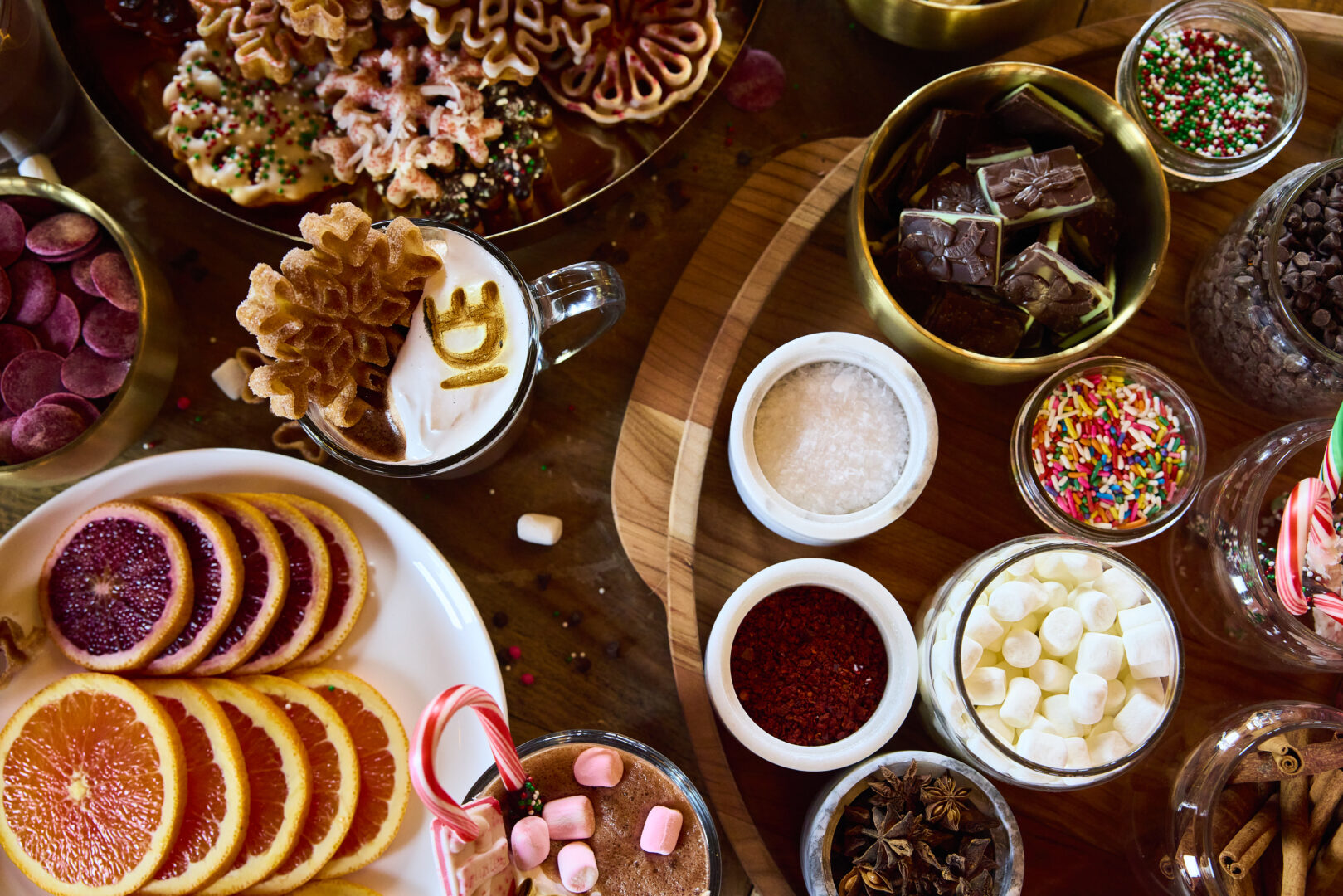 Array of hot chocolate add-ins and a branded hot chocolate with cookies.