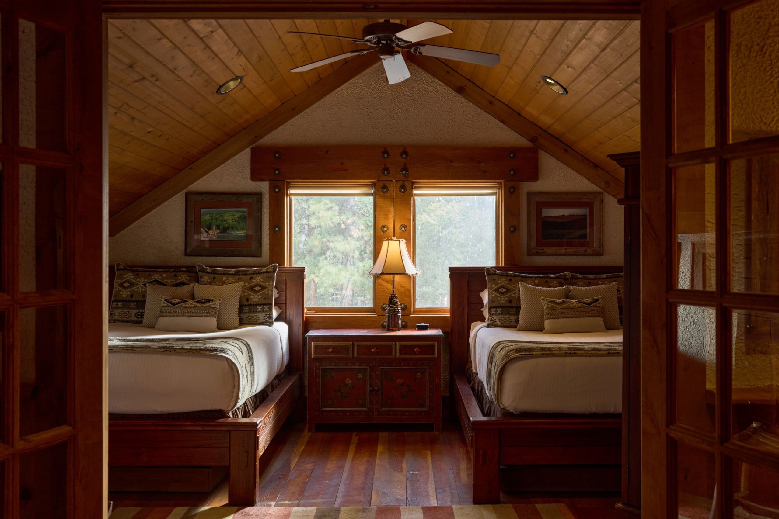 Two full beds in a western style cabin