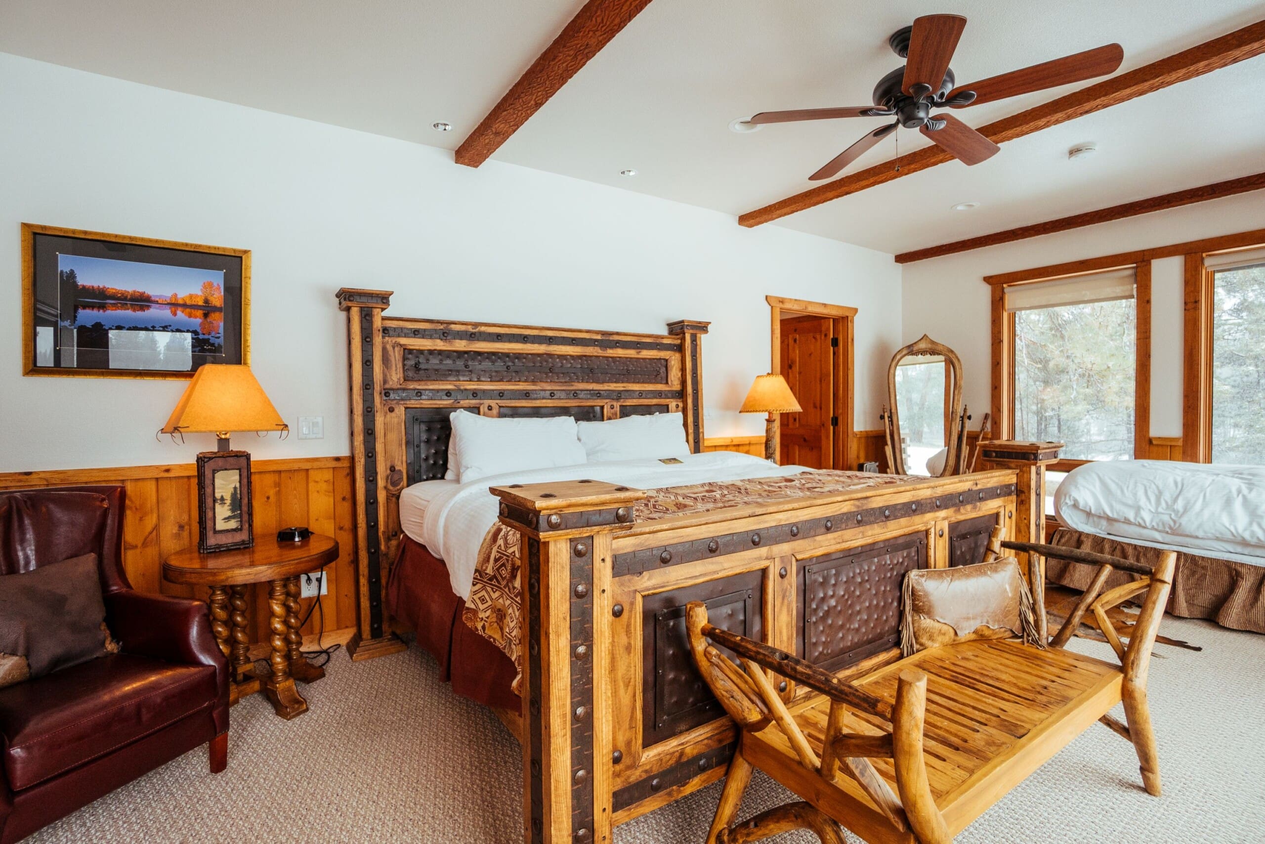 Western style bedroom with king size bed inside wooden lodge