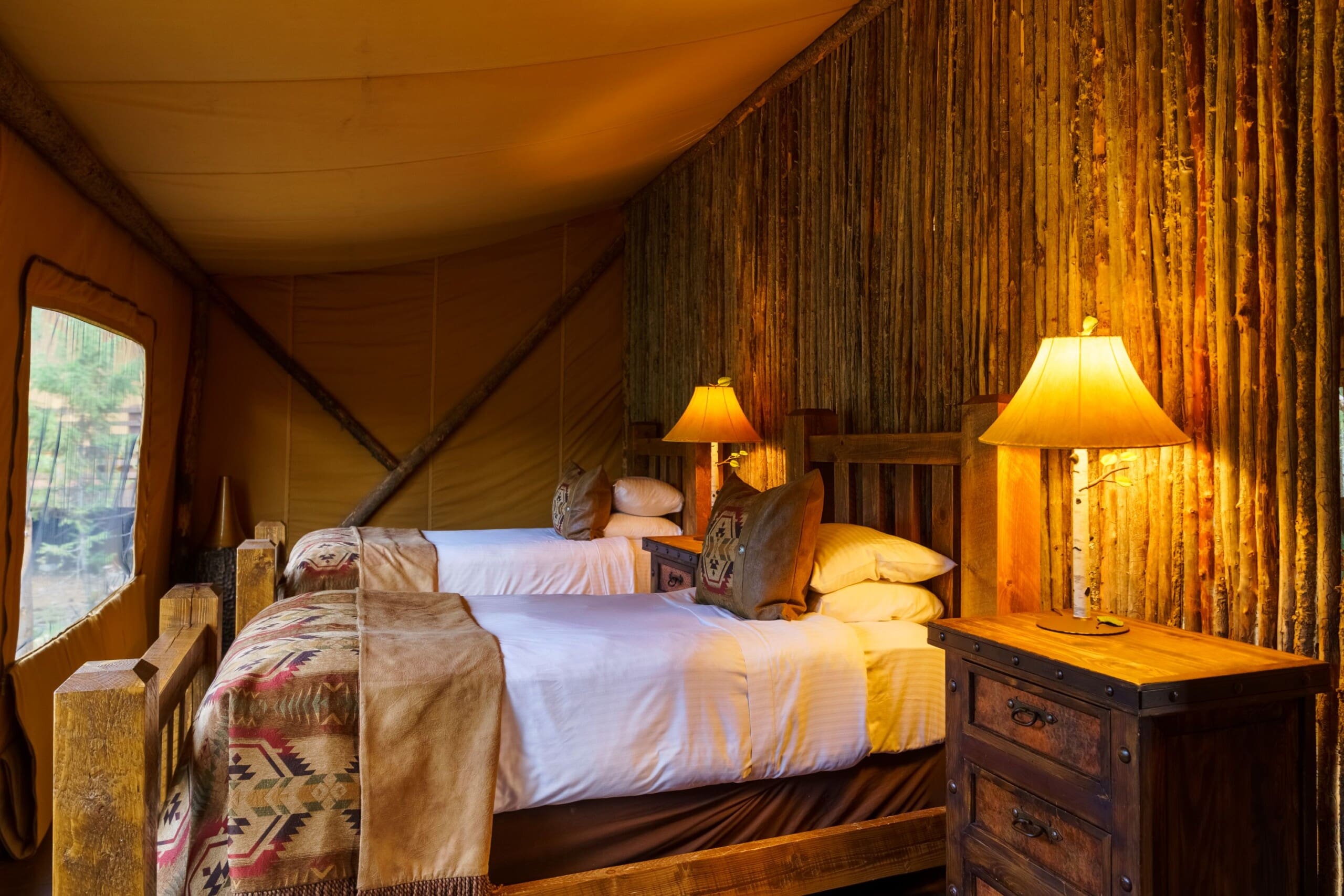 Interior of glamping canvas tent bedroom with twin beds