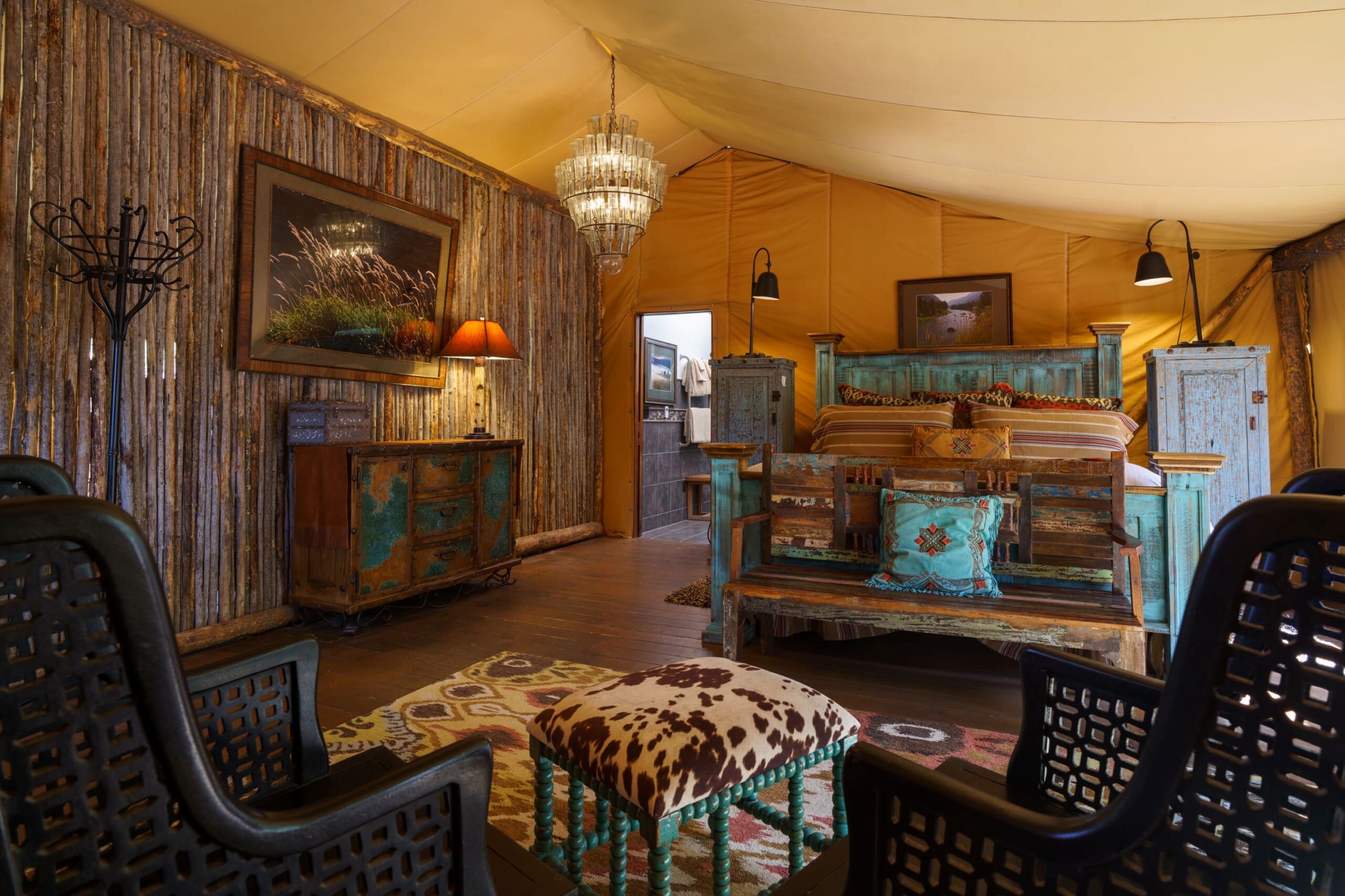 Interior of luxury canvas glamping tent with king size bed