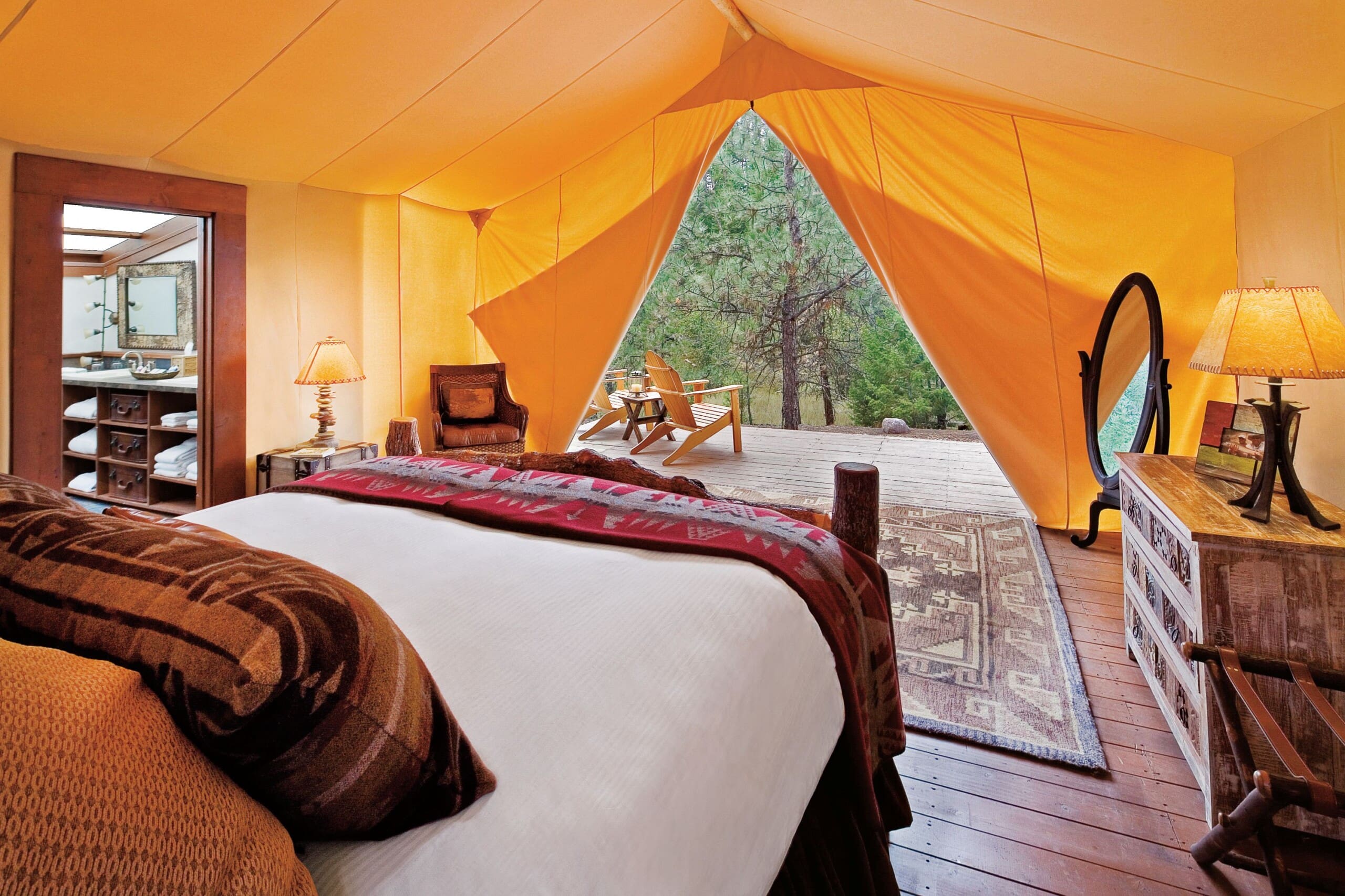 Interior of luxury canvas glamping tent with king size bed