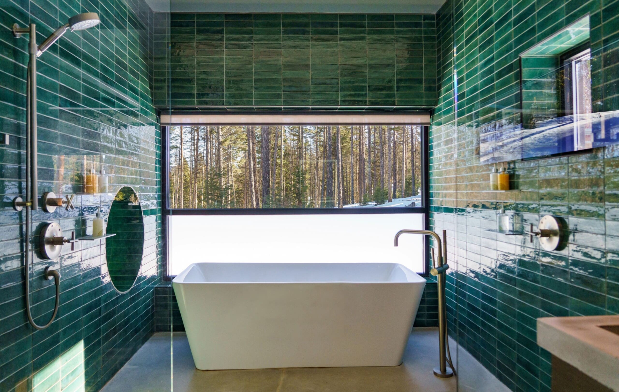 Interior of modern cabin bathroom with green tile and bathtub