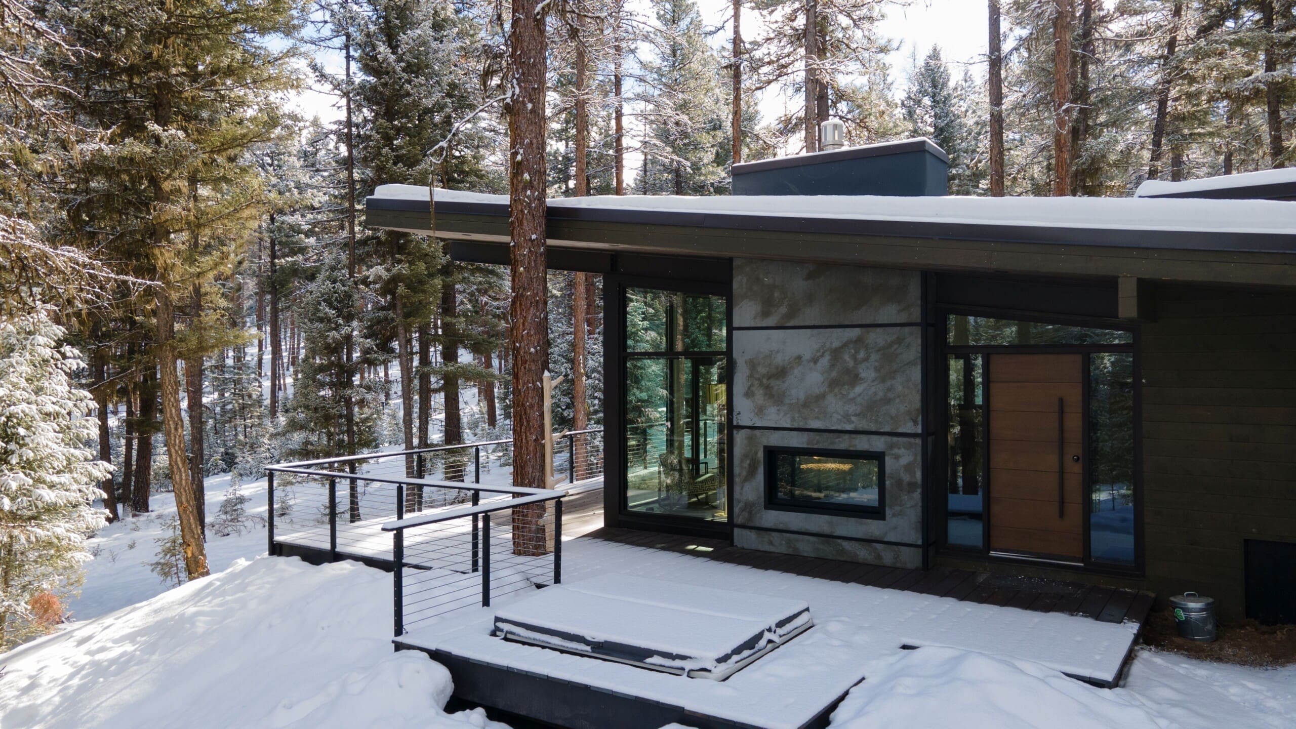 winter exterior of modern cabin in the forest