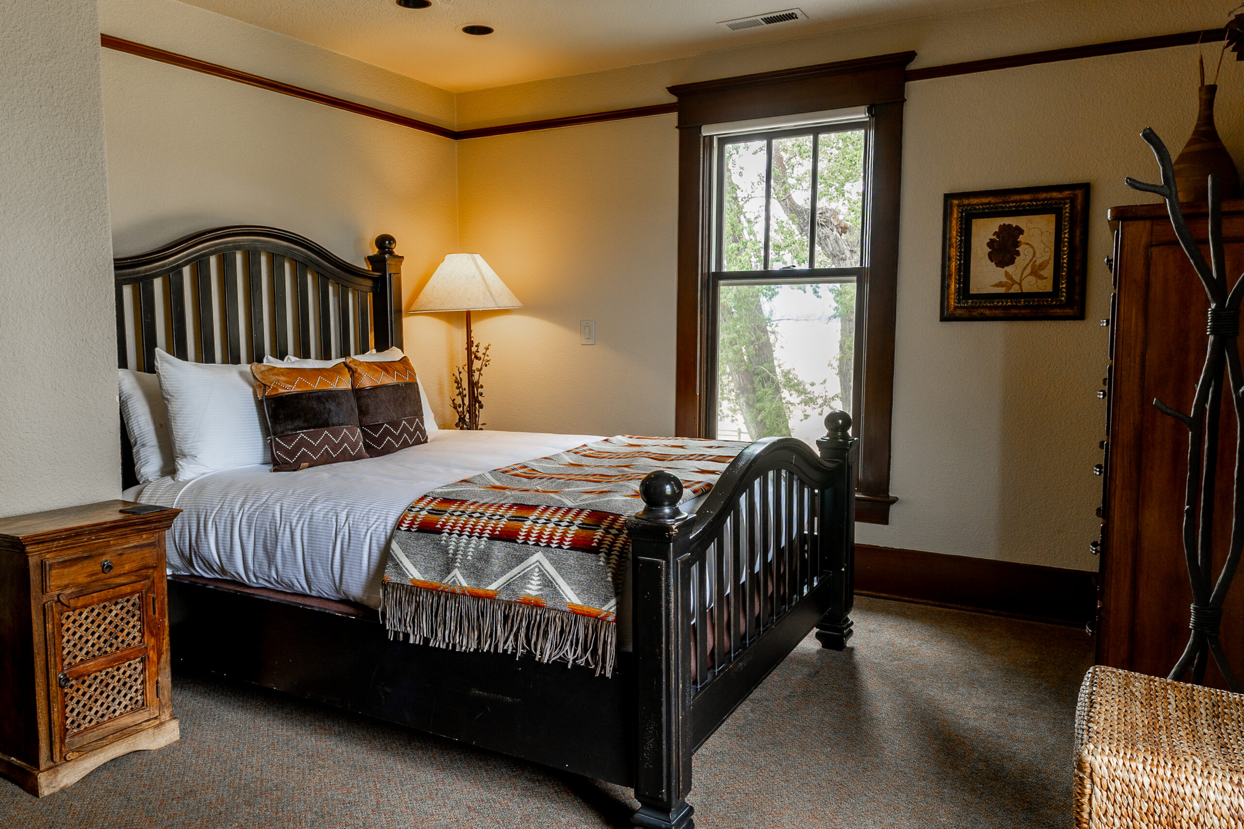 Western looking bedroom with a bed on a wooden platform.