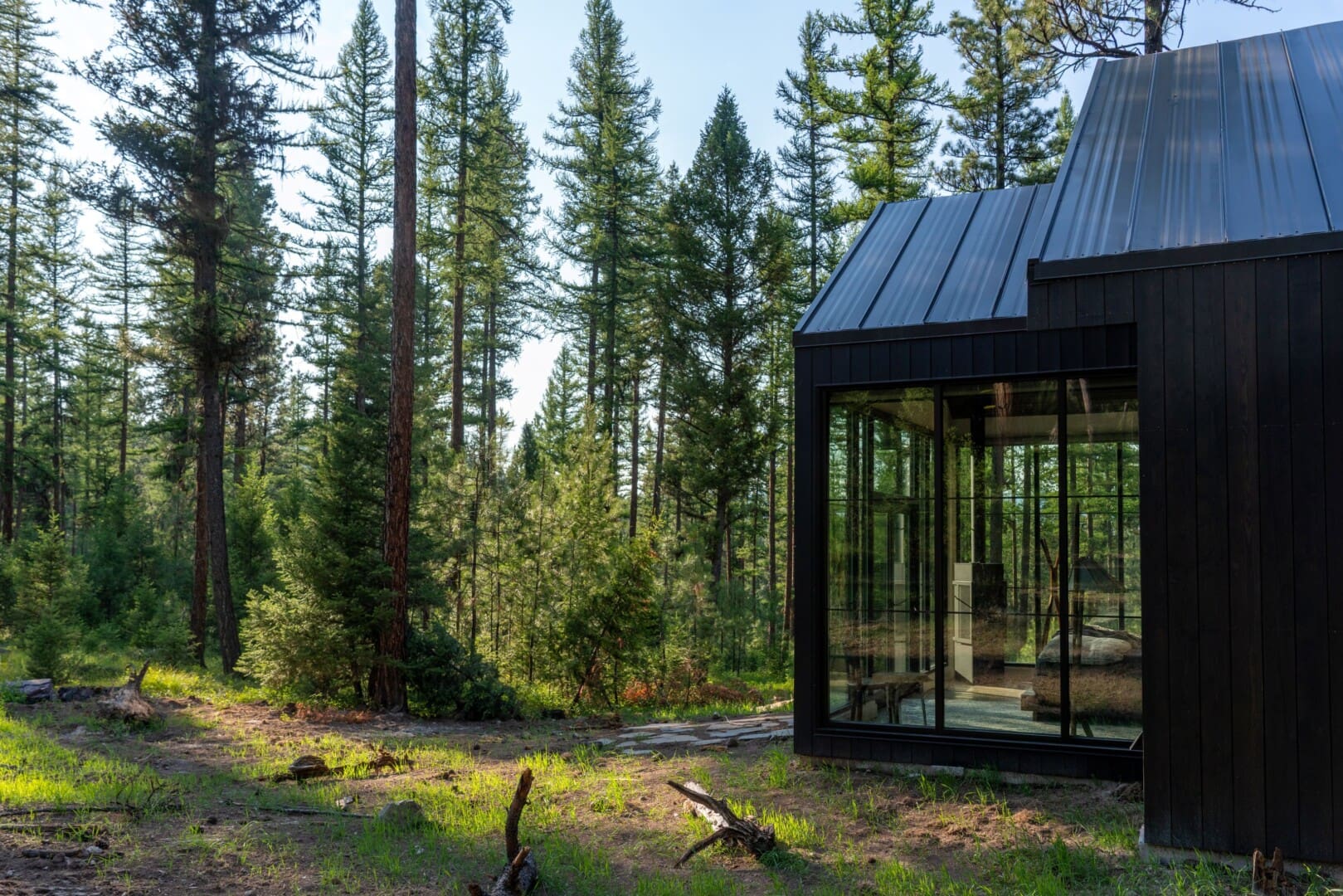 Outside of glass modern cabin in the woods