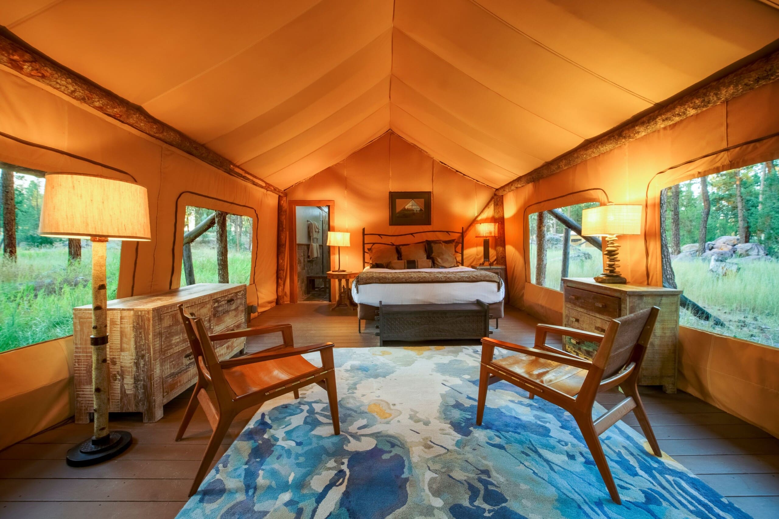 Interior of canvas glamping tent with king size bed