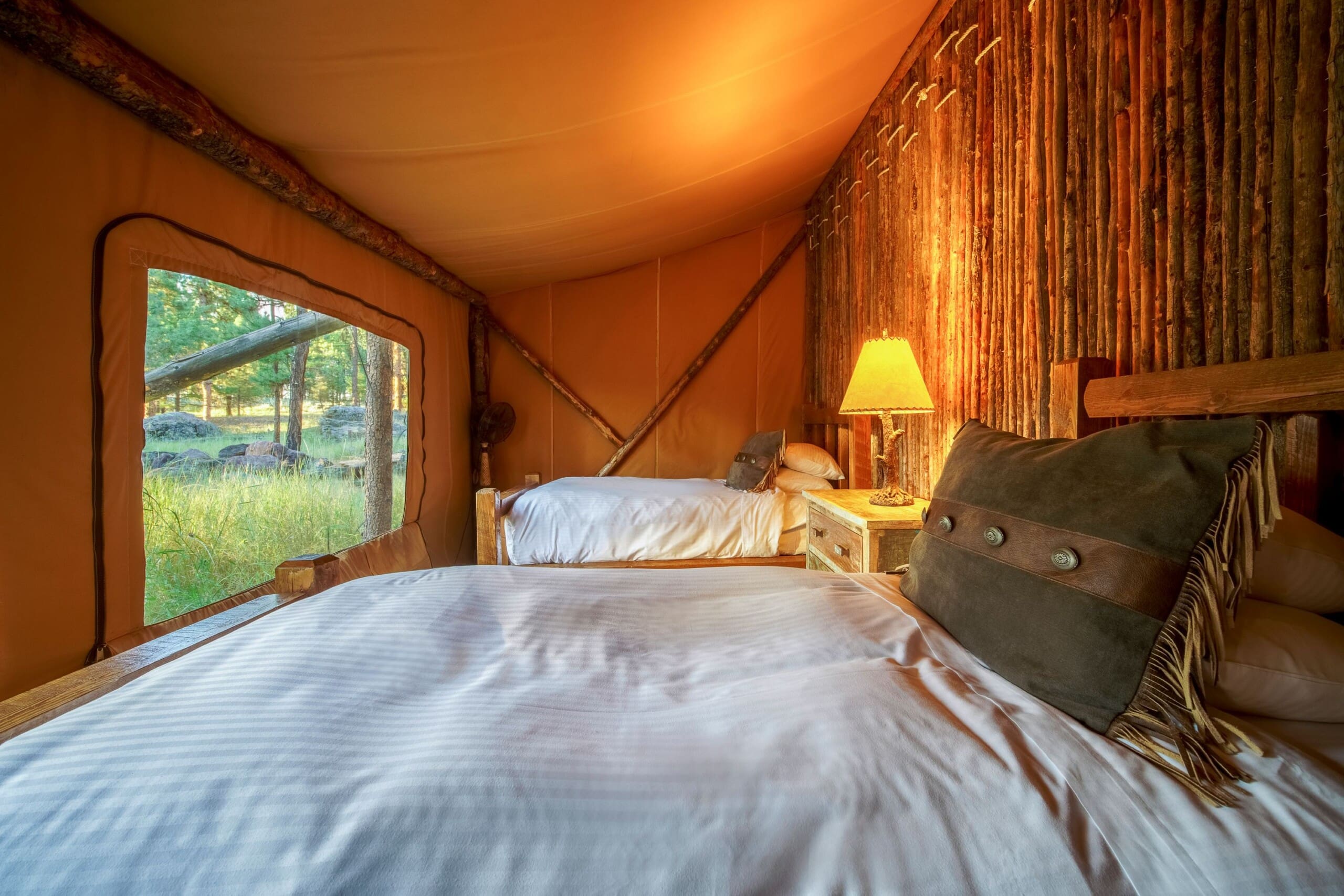 Two twin beds in a canvas glamping tent