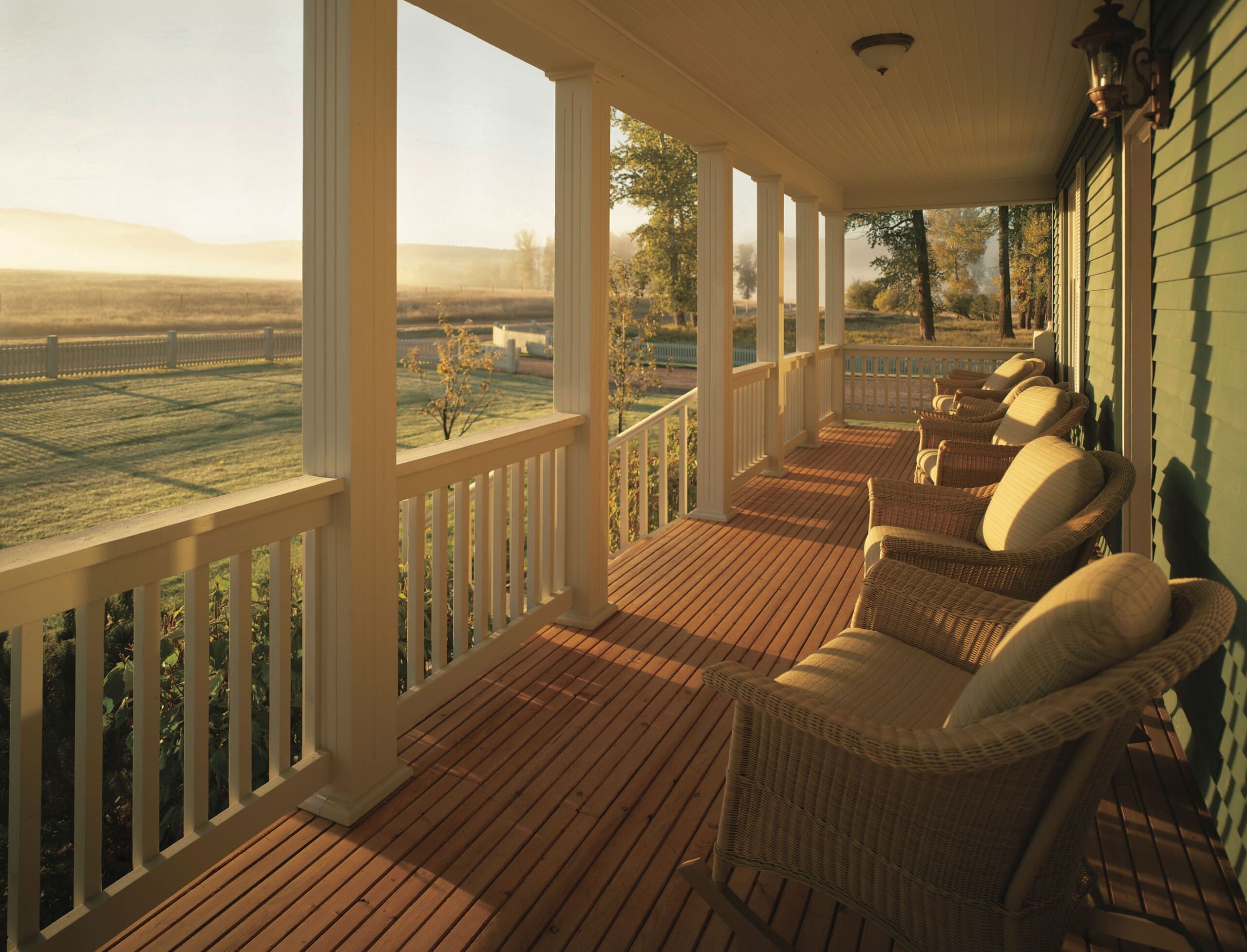 Farmhouse porch with chairs and ranch view