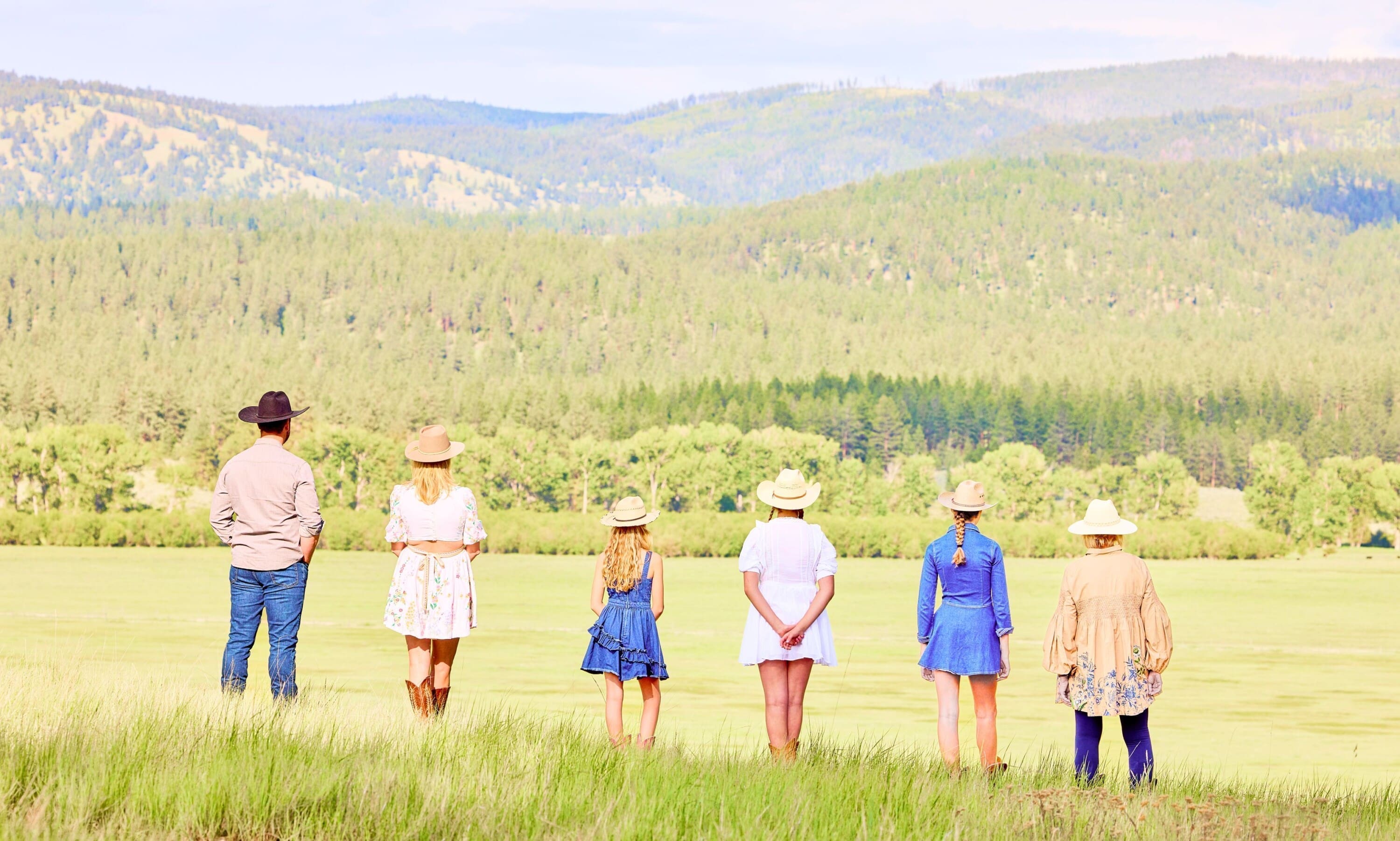 Family members lined up looking at a mountain view
