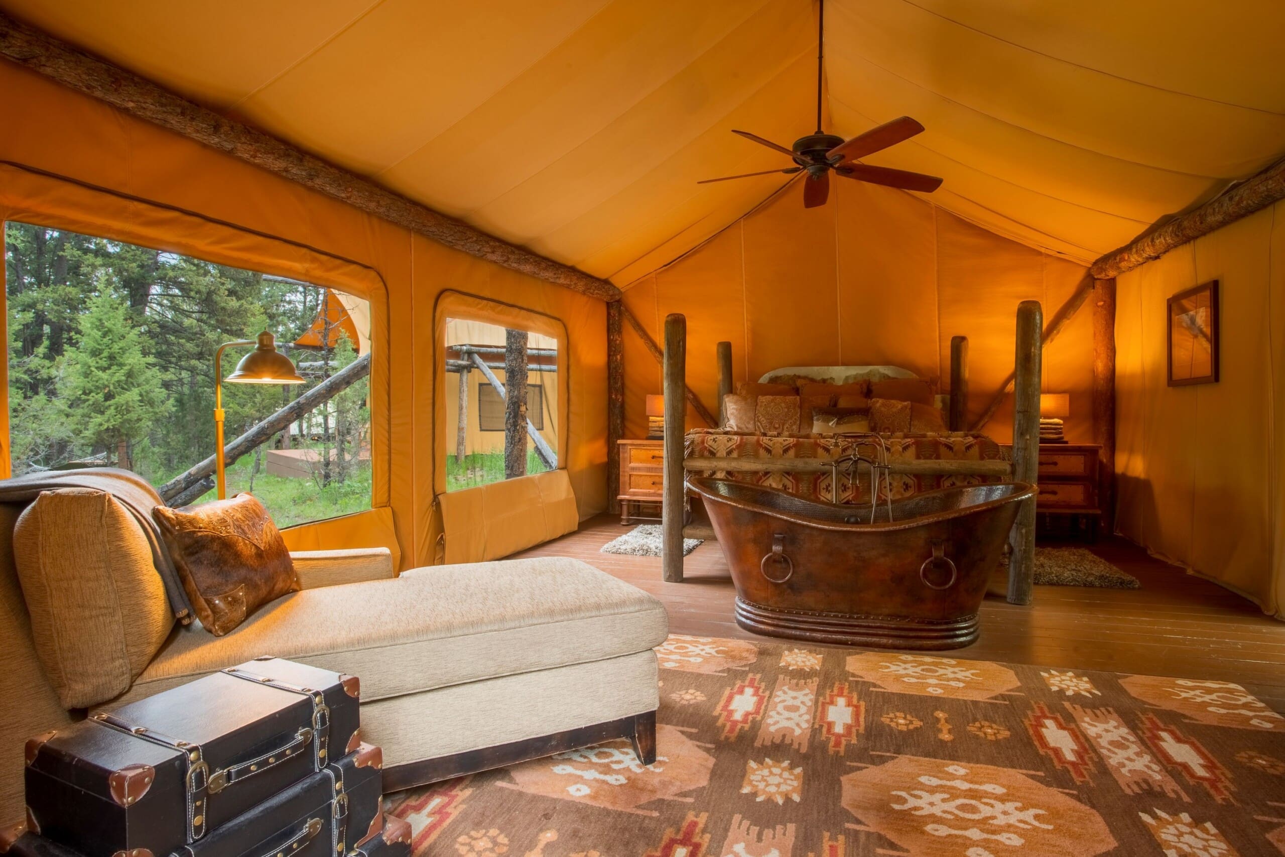 Interior of bedroom in glamping tent with king size bed