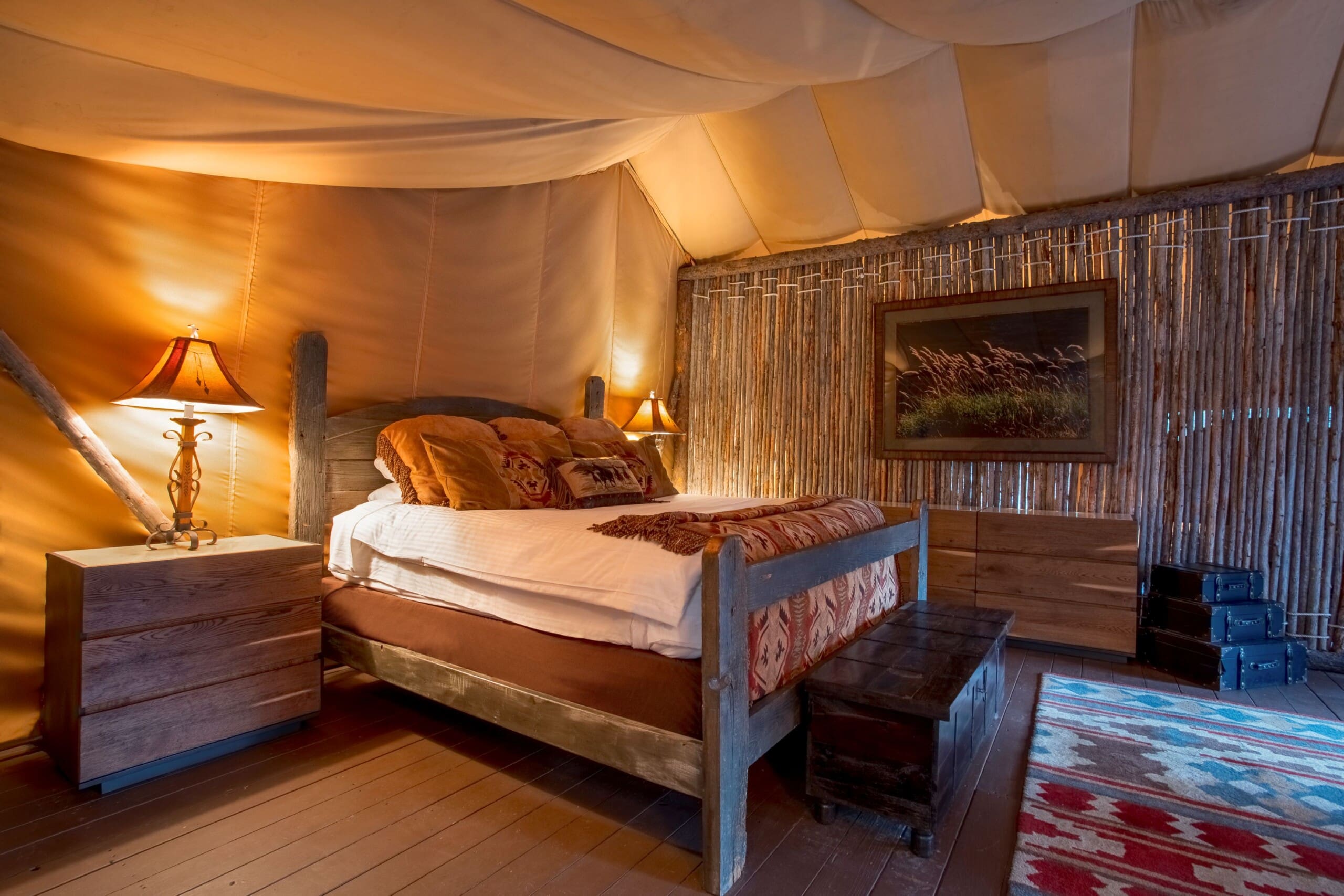 Interior of bedroom in glamping tent with king size bed