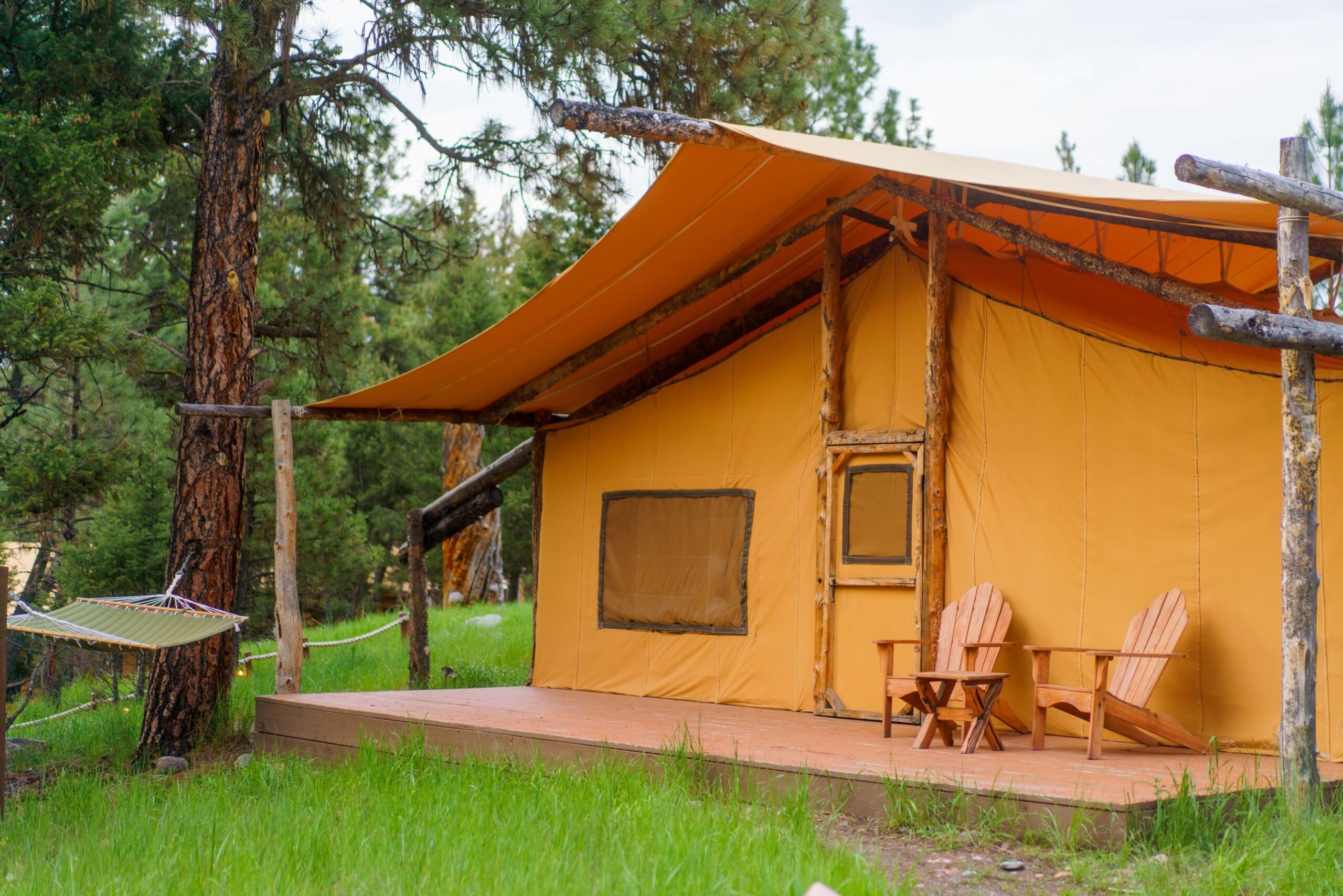 Outside of a yellow canvas glamping tent