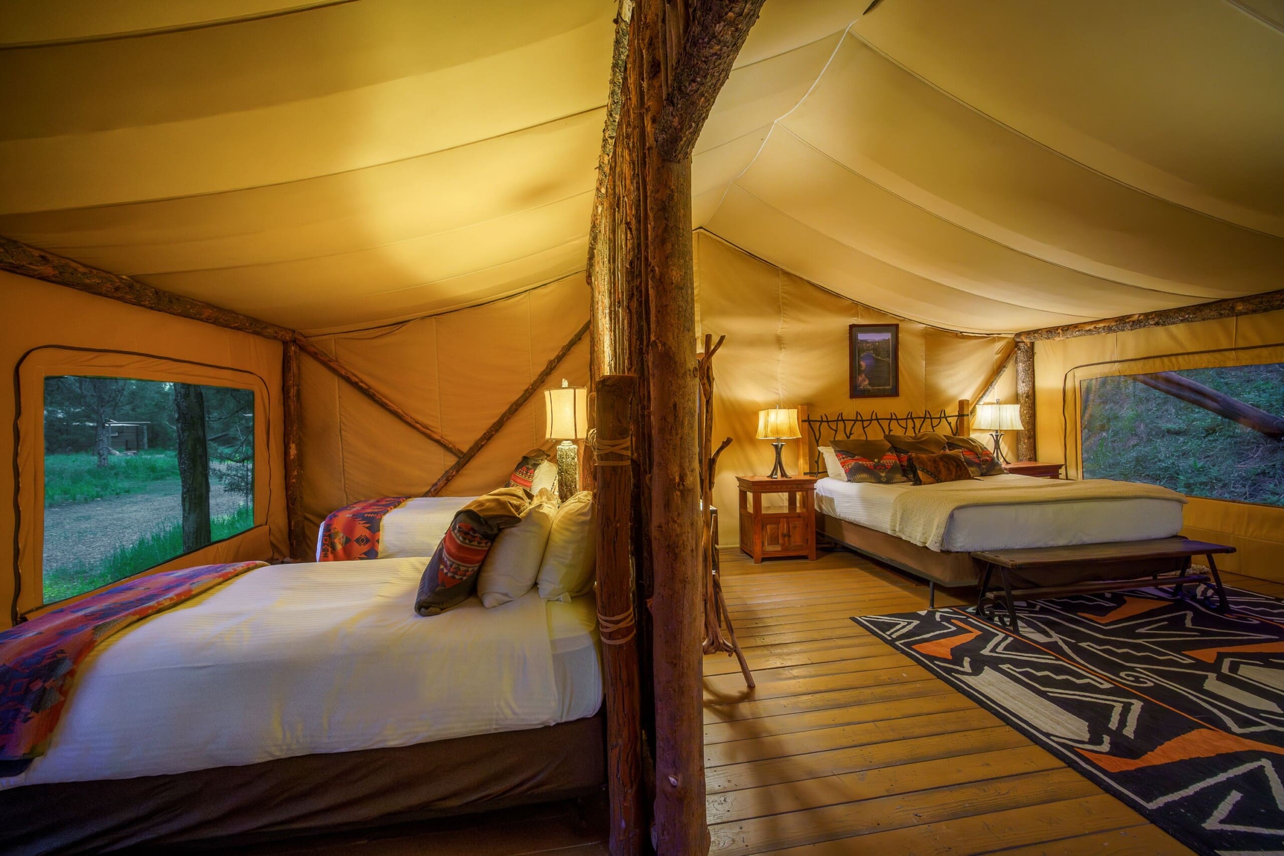 Two bedroom glamping tent with two twin beds and a king size bed