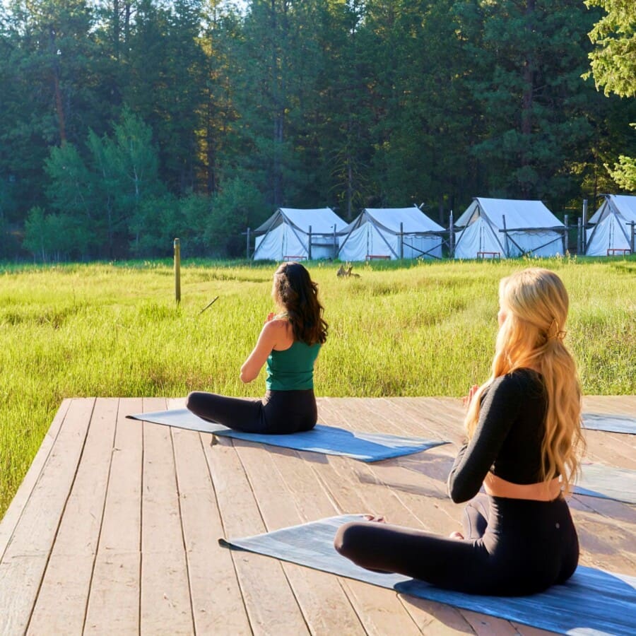 Women doing yoga on a deck outside