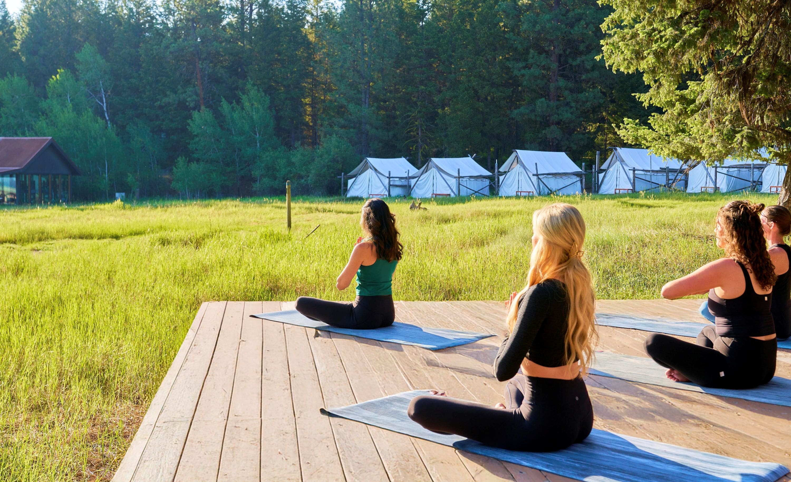 Women doing yoga on a deck outside