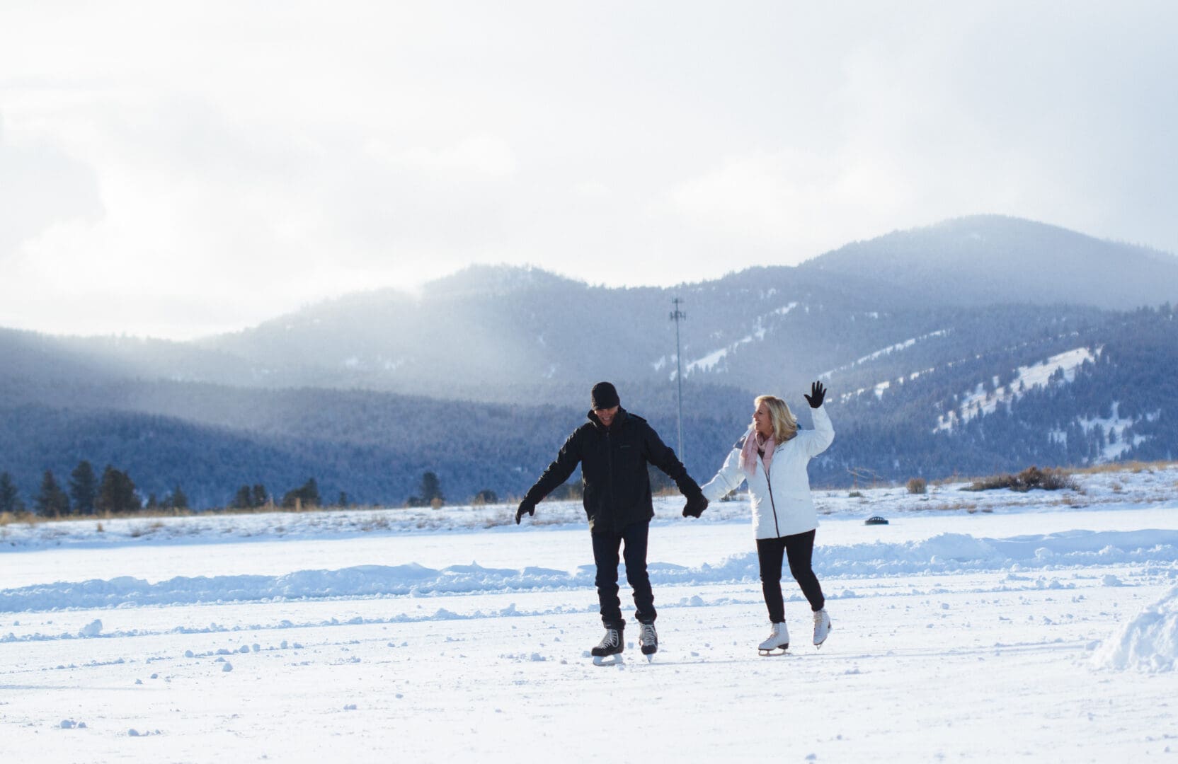 Couple ice-skating in the winter.