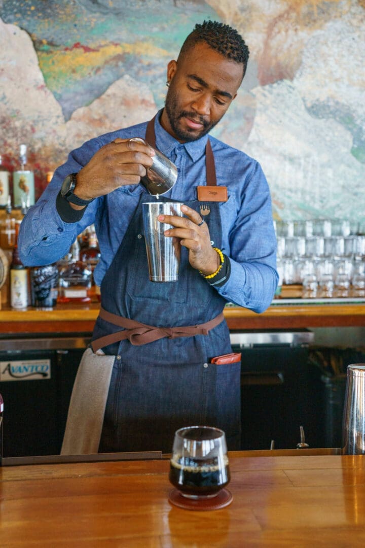 Bartender making a cocktail at a fancy bar.