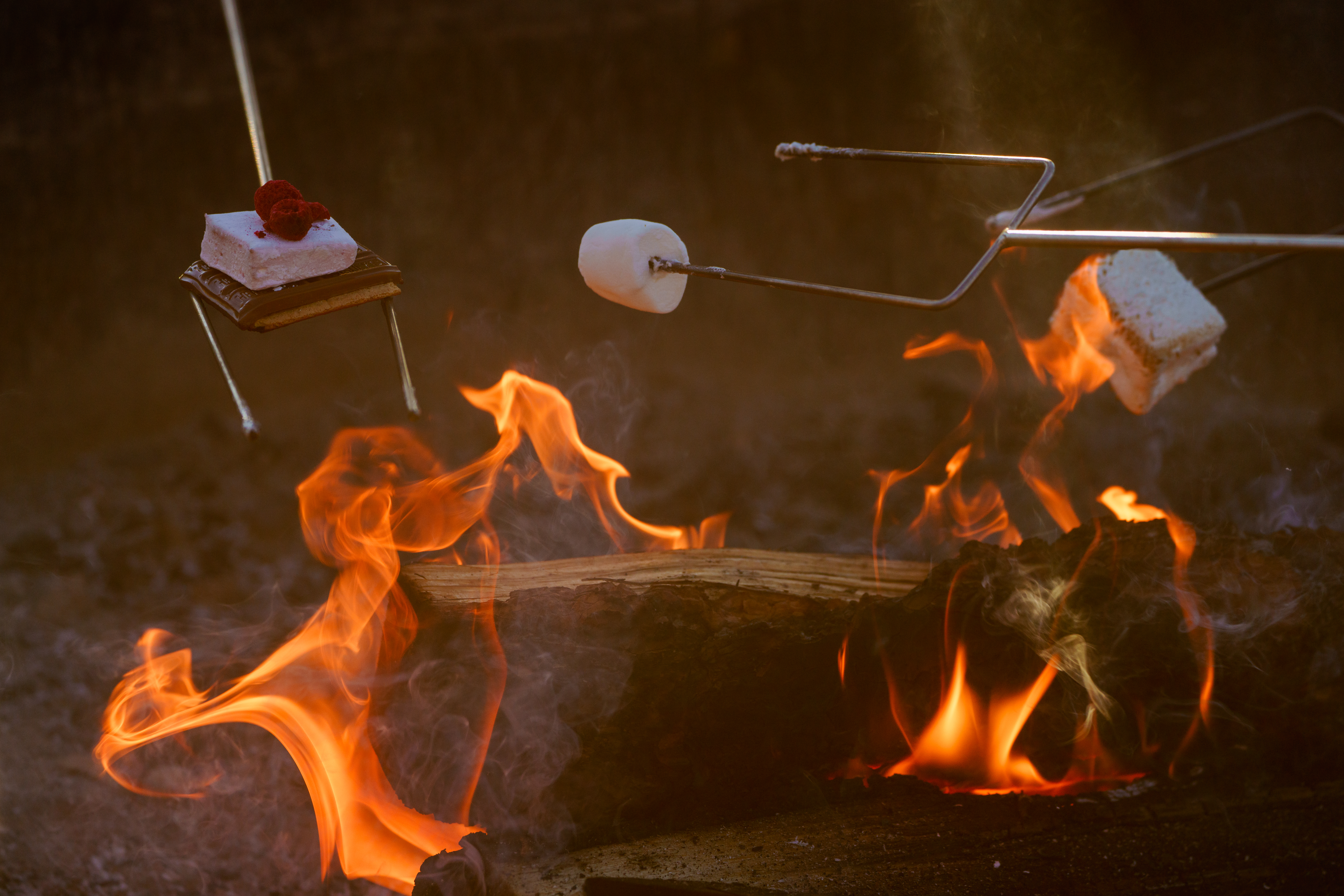 Roasting smores over a campfire.