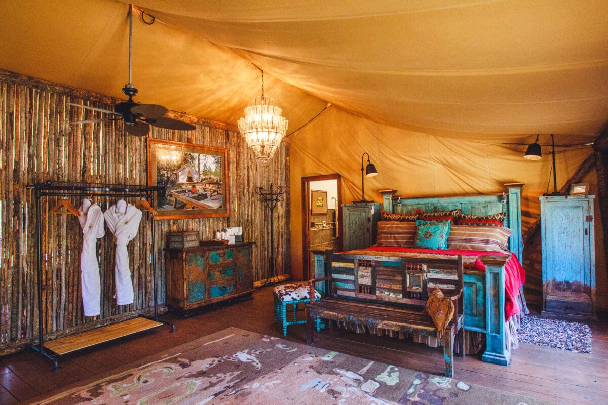 Inside of a glamping tent with western themed decorations and a chandelier.
