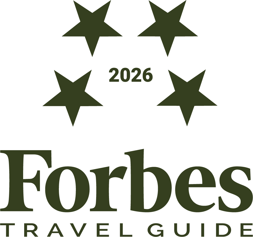 Forbes 2026 travel standards logo in color legacy pine.