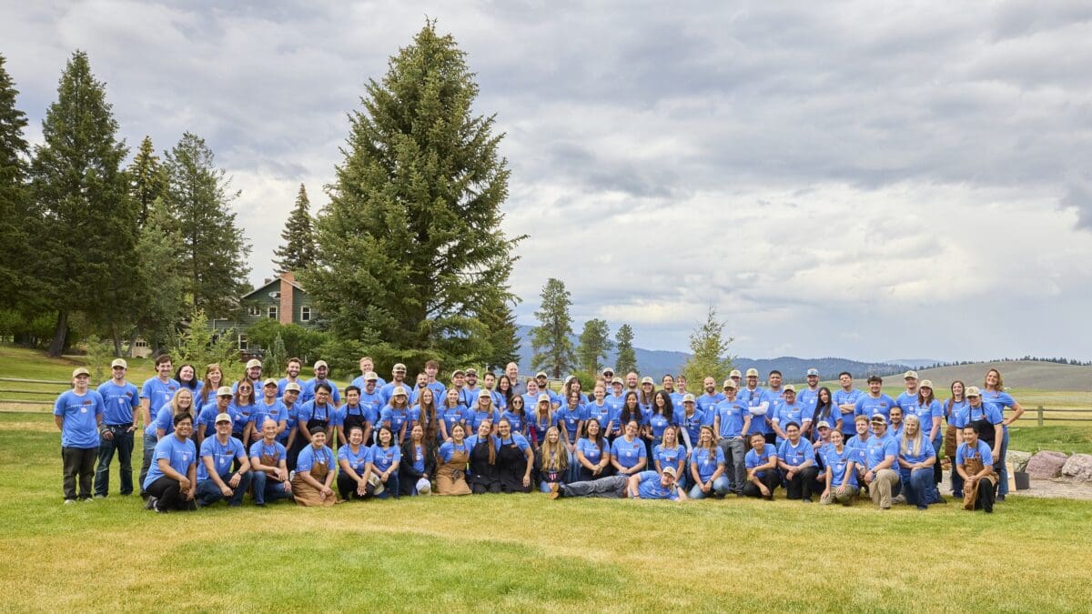 Photo of staff members outside wearing matching blue shirts.