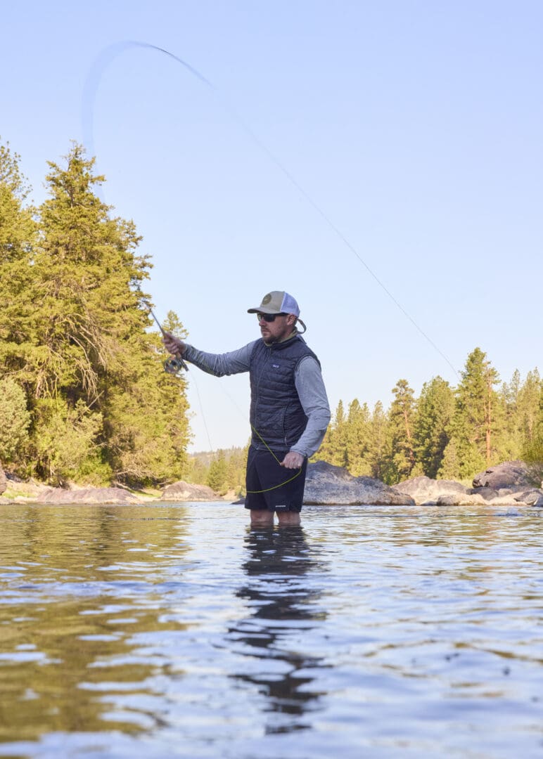 Man fishing in a river.