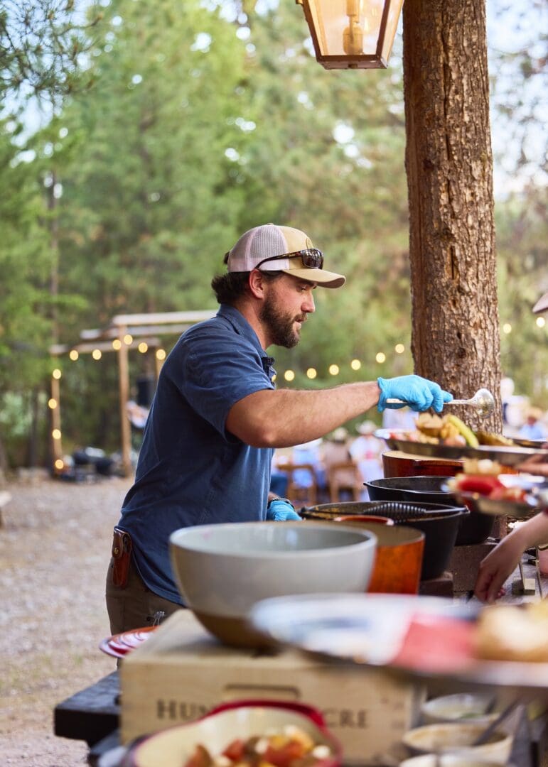 Chef working at a western themed outside dining area cooking food.