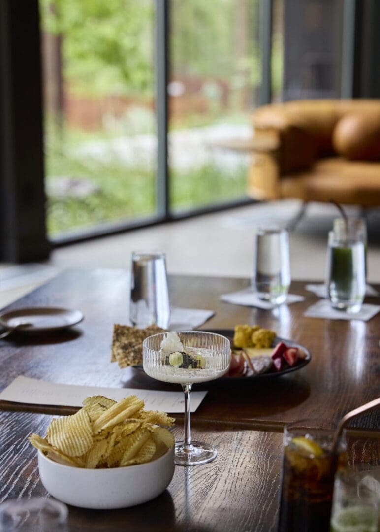 Fries and drink sitting on a nice table inside a windowed area.