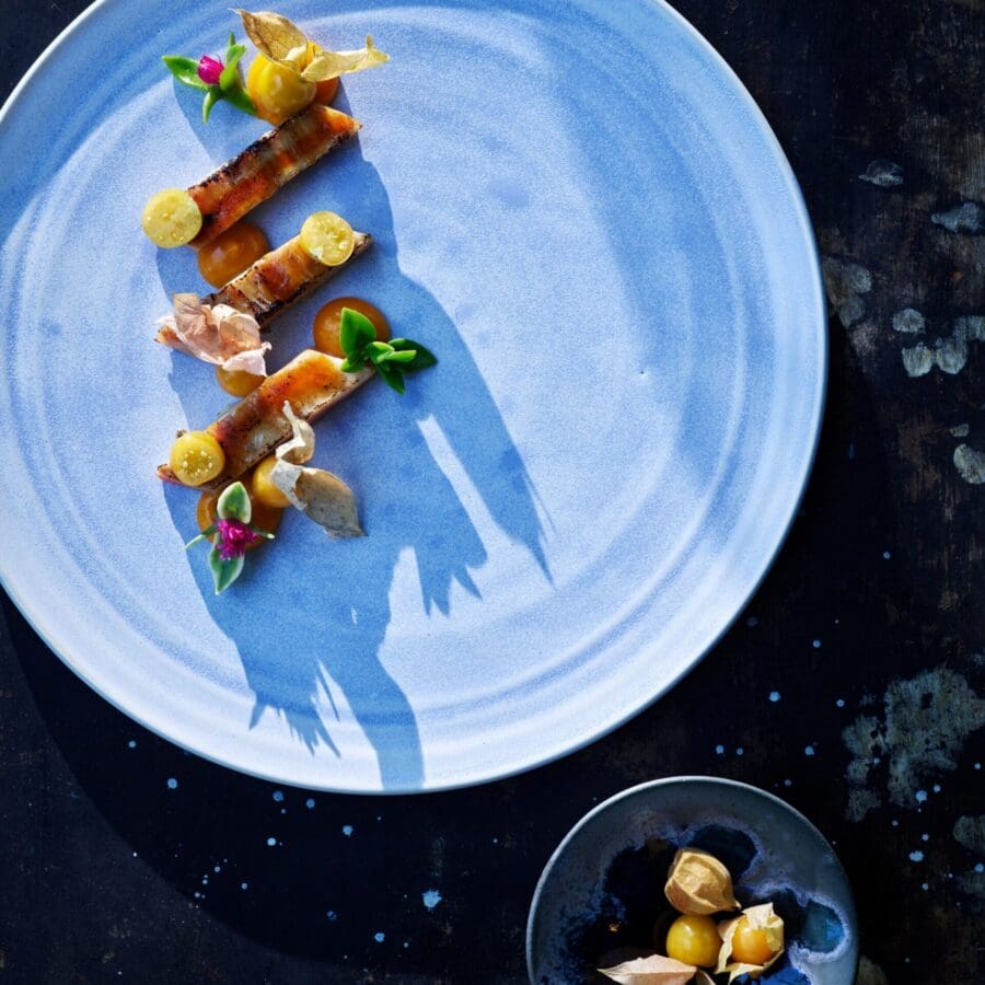 A light blue plate featuring a fancy but simple food dish.