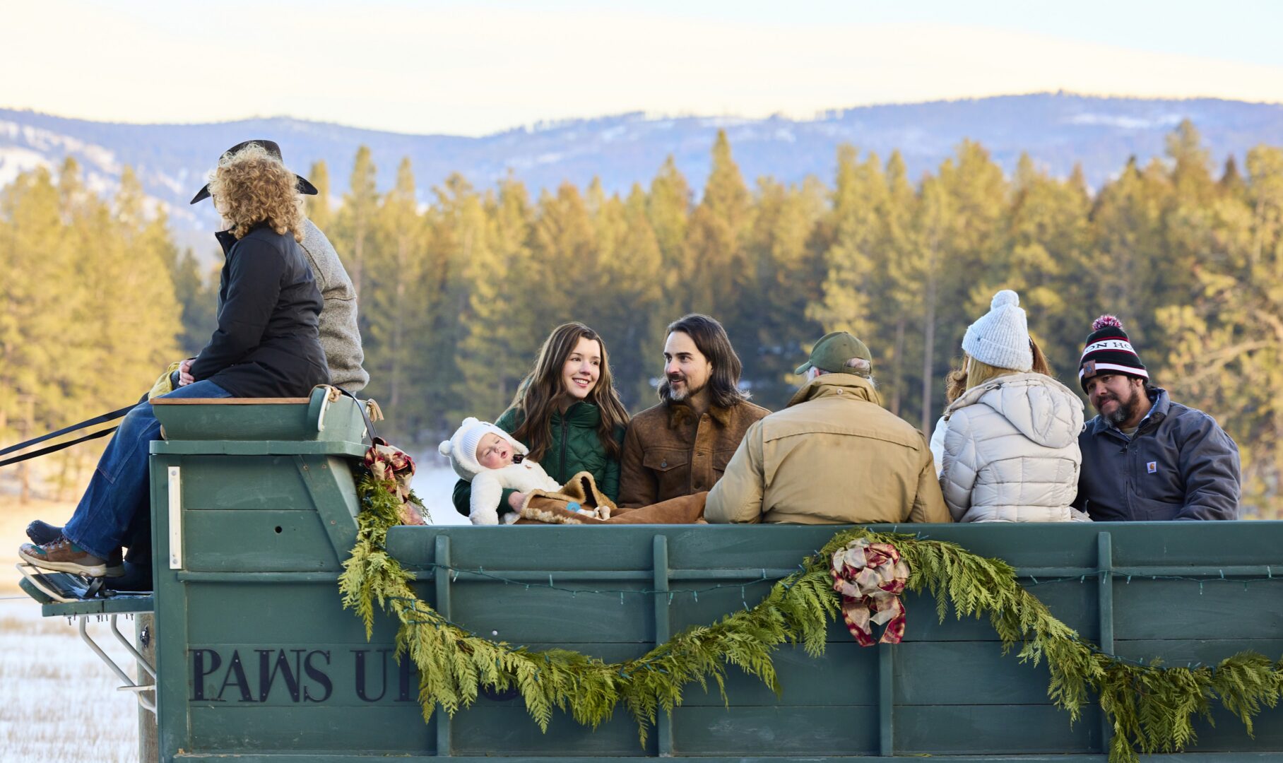 A family riding in a green carriage.