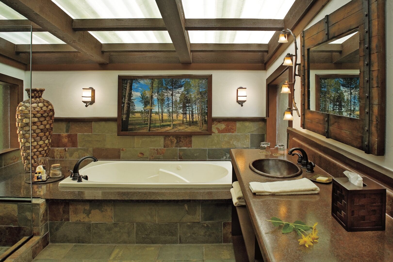 Inside of a fancy bathroom with wooden panels and western themed paintings.